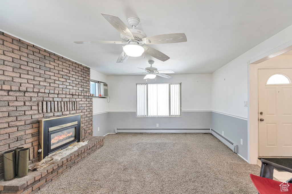 Unfurnished living room with a fireplace, a healthy amount of sunlight, light carpet, and ceiling fan