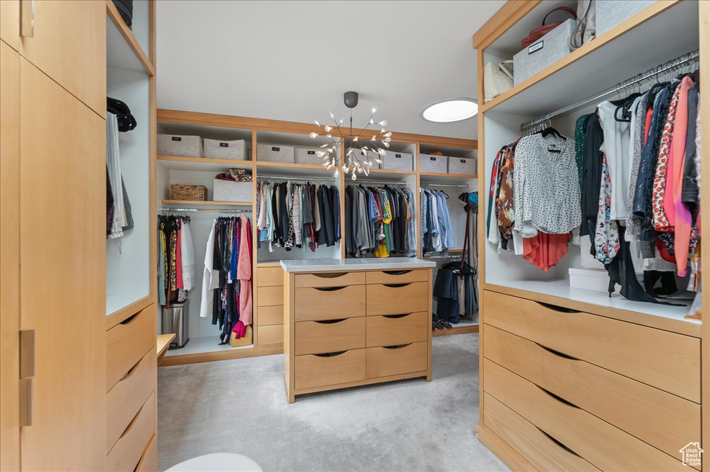 Spacious closet featuring a notable chandelier