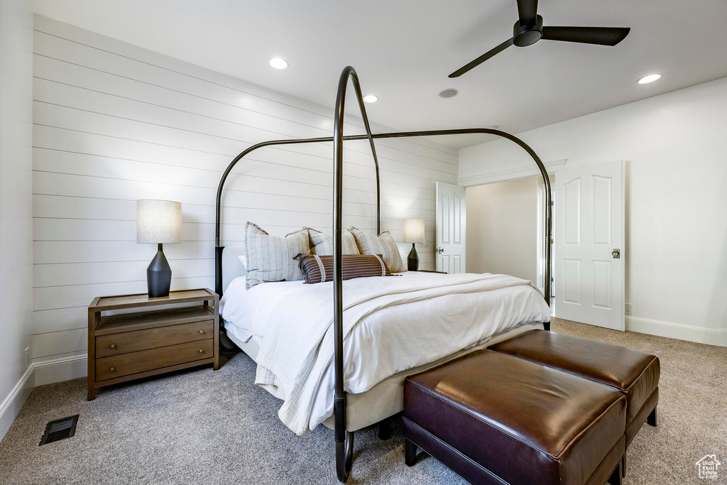 Carpeted bedroom featuring ceiling fan