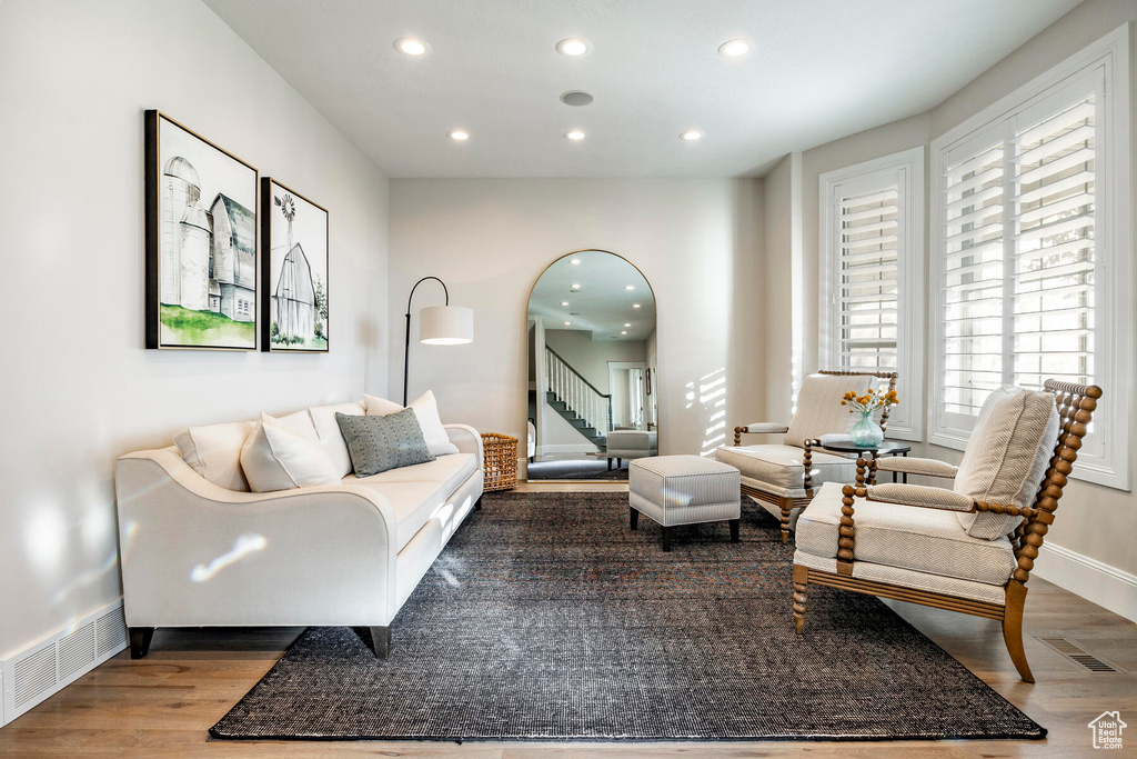 Living area with plenty of natural light and light hardwood / wood-style flooring