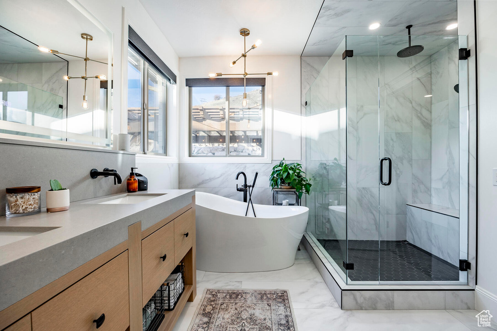 Bathroom featuring tile patterned floors, independent shower and bath, vanity, and tile walls