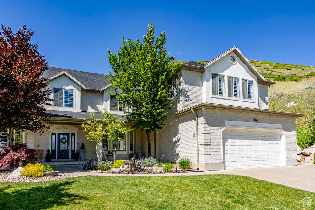 View of front property with a front lawn and a garage