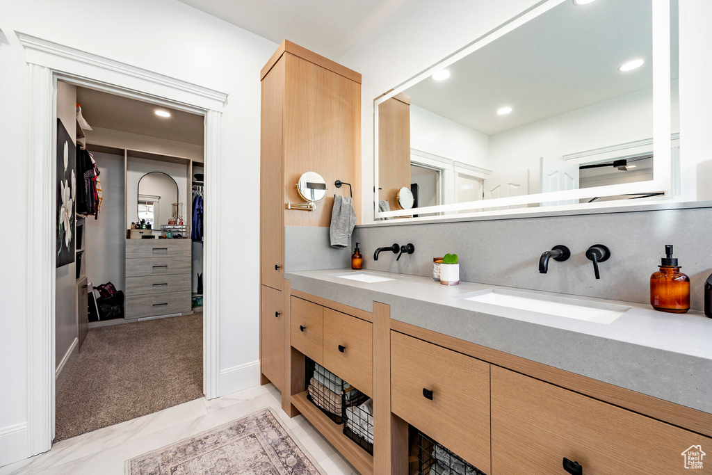 Bathroom featuring tile patterned flooring and vanity