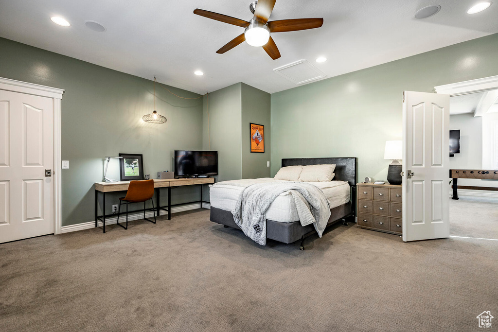 Carpeted bedroom featuring ceiling fan