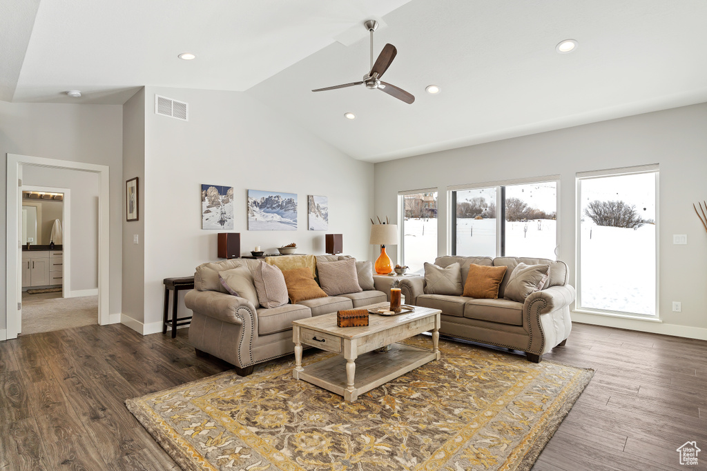 Living room featuring high vaulted ceiling, dark hardwood / wood-style floors, and ceiling fan