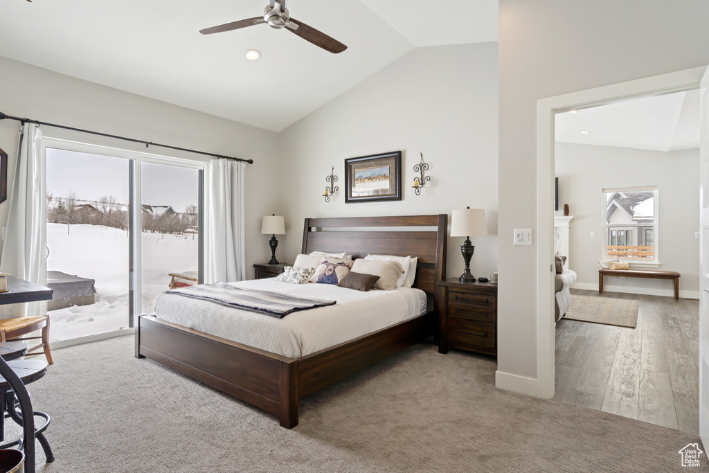 Bedroom featuring access to outside, high vaulted ceiling, light colored carpet, and ceiling fan