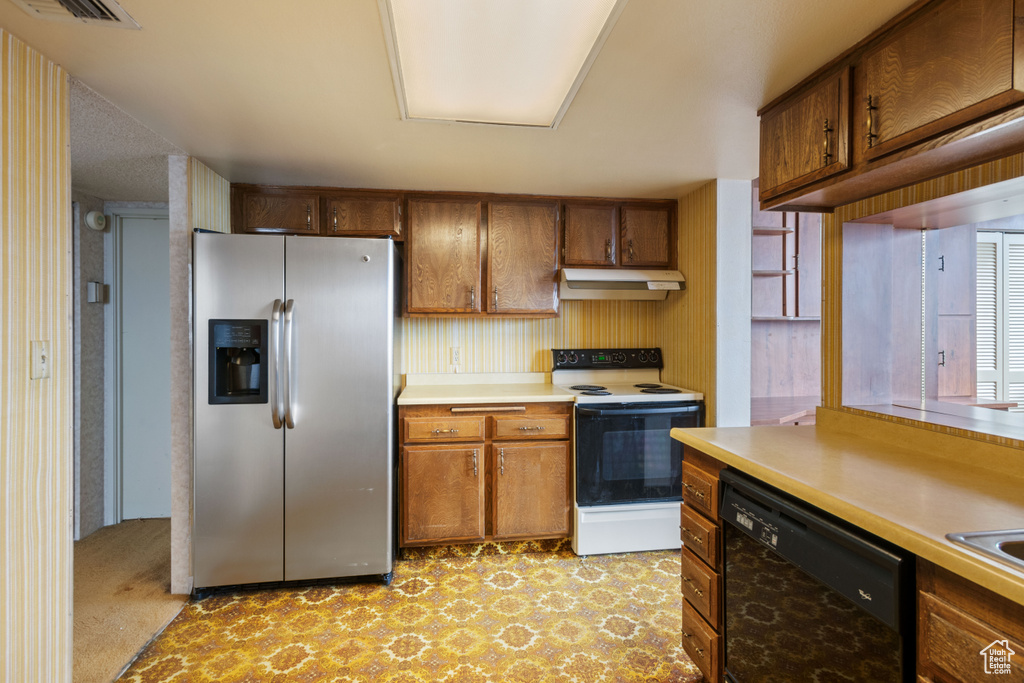 Kitchen with light colored carpet, stainless steel fridge, white range with electric cooktop, and dishwasher
