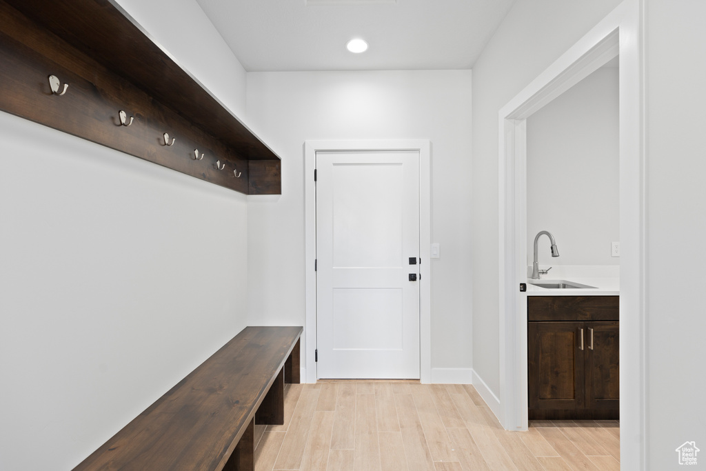 Mudroom with light hardwood / wood-style floors and sink