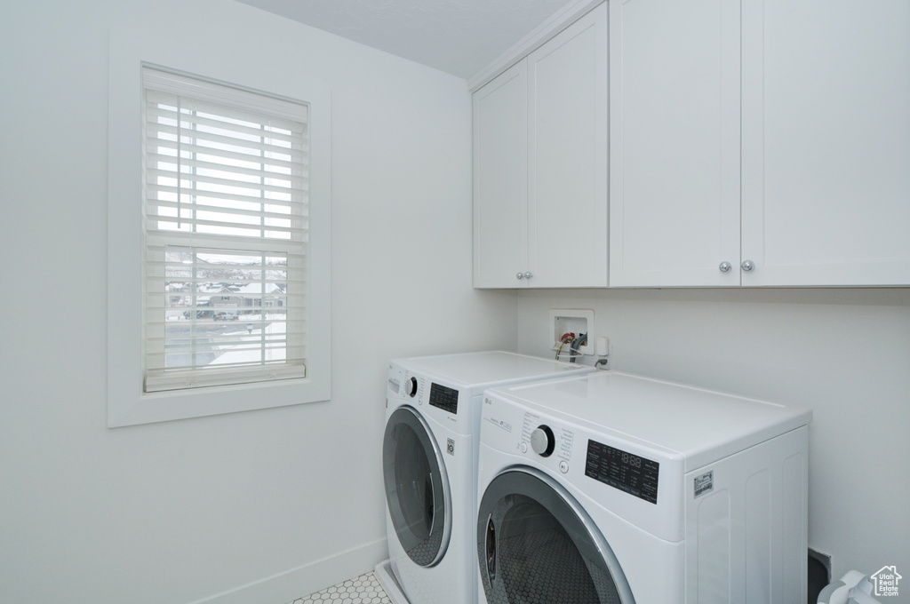 Laundry room featuring hookup for a washing machine, cabinets, tile flooring, and independent washer and dryer
