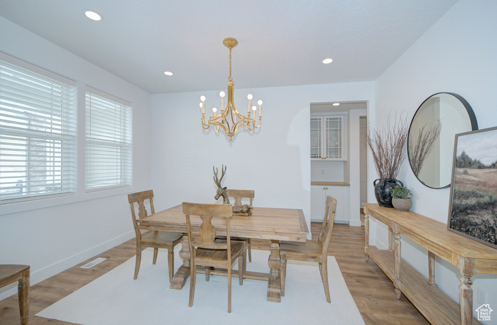 Dining space featuring a chandelier and light hardwood / wood-style flooring