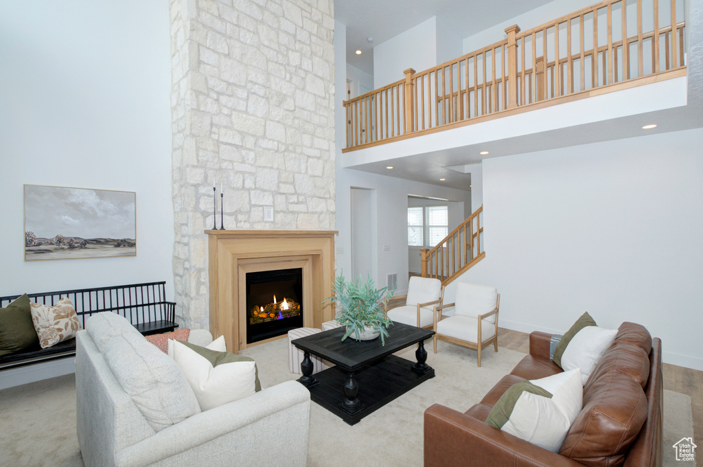 Living room with a fireplace and a towering ceiling