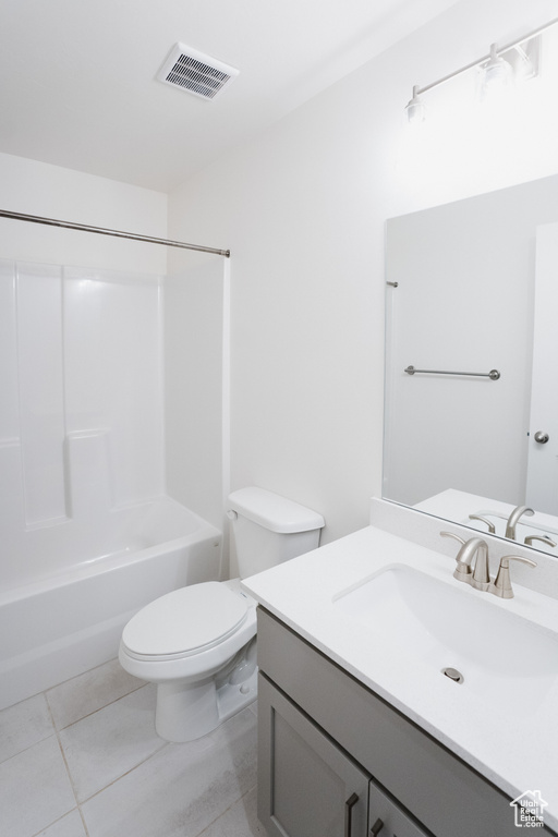 Full bathroom featuring shower / washtub combination, tile floors, oversized vanity, and toilet
