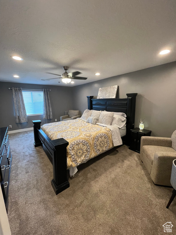 Bedroom featuring a textured ceiling, carpet flooring, and ceiling fan