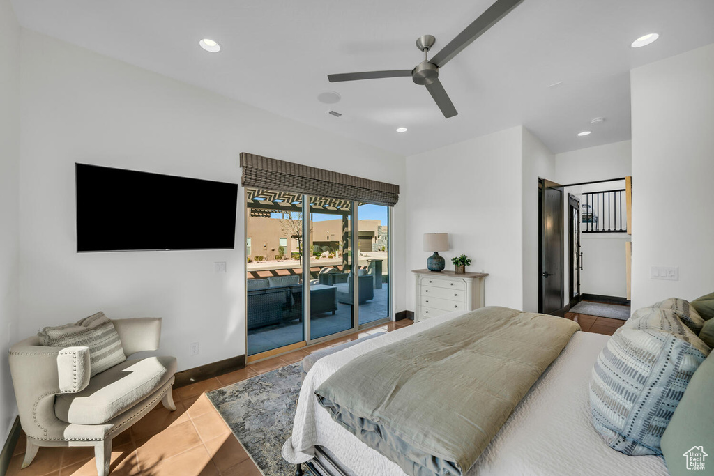 Bedroom with dark tile flooring, access to exterior, and ceiling fan
