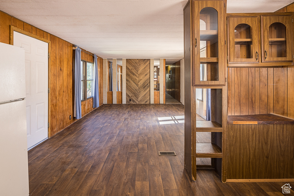 Interior space with wood walls and dark hardwood / wood-style floors