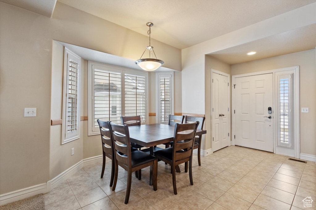 Dining area featuring light tile flooring and a healthy amount of sunlight