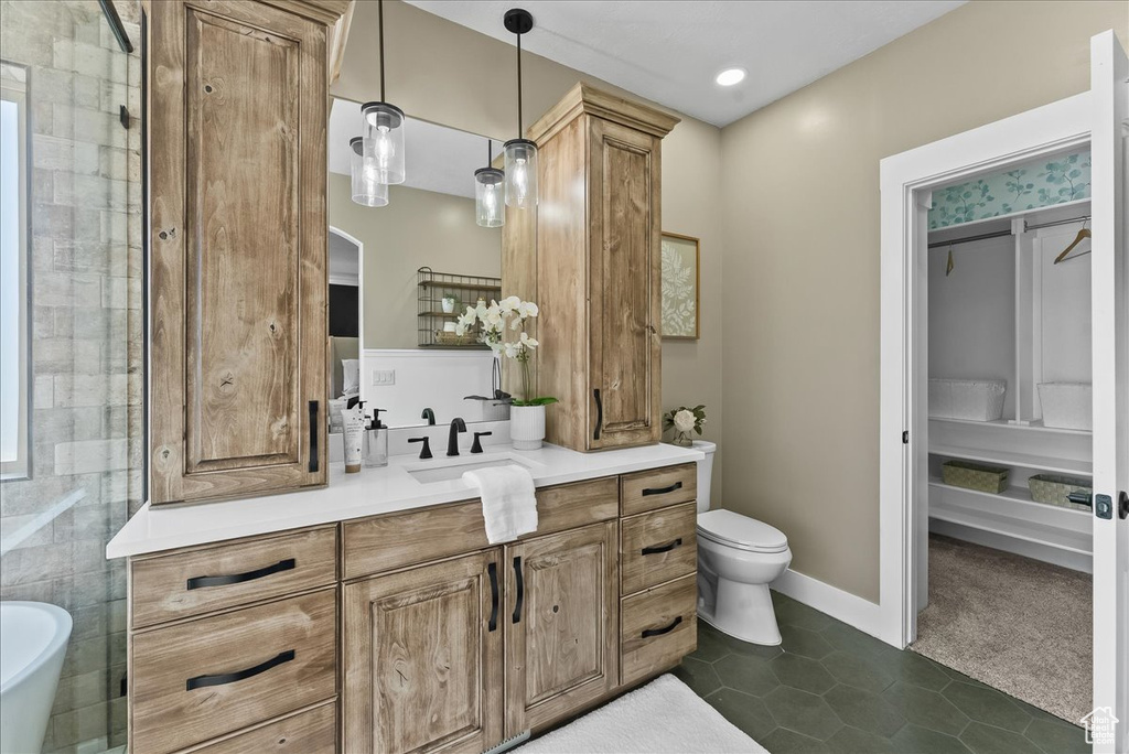 Bathroom featuring vanity, tile walls, toilet, tile flooring, and a bathing tub