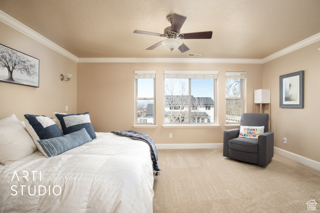 Bedroom featuring light colored carpet, ceiling fan, and ornamental molding