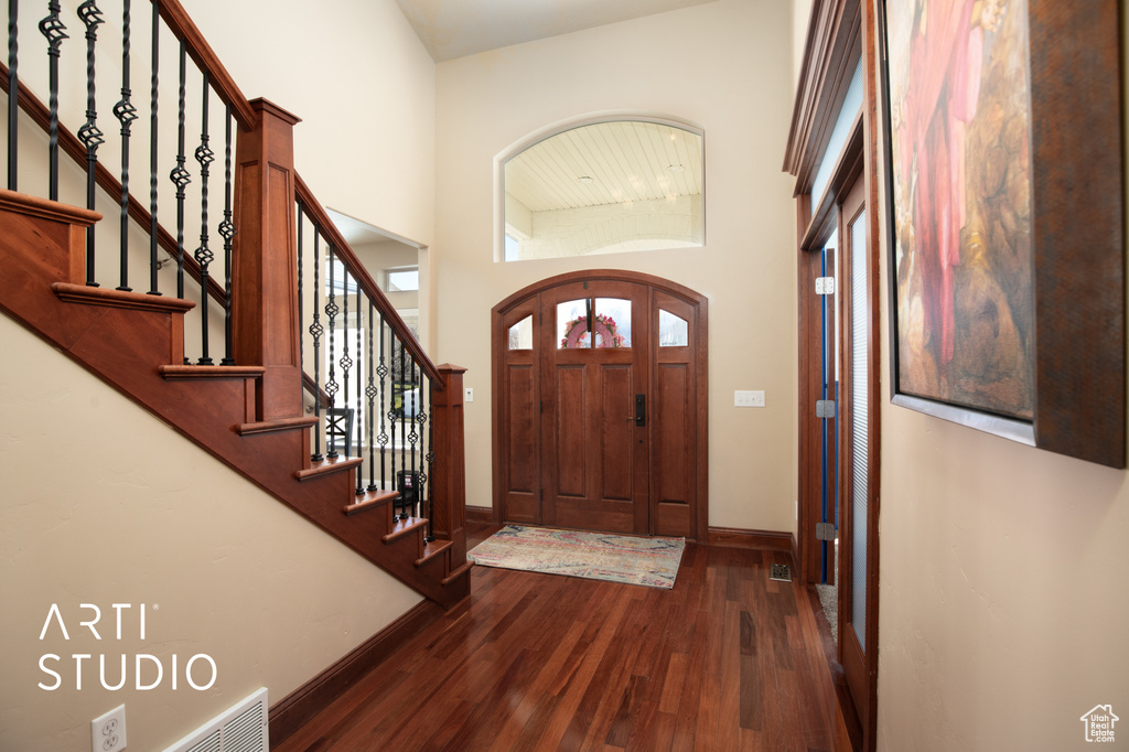 Entryway featuring high vaulted ceiling and dark hardwood / wood-style floors