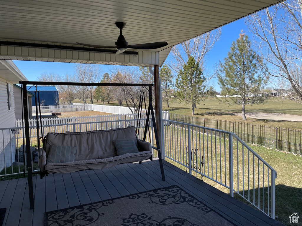 Wooden deck with a yard and ceiling fan