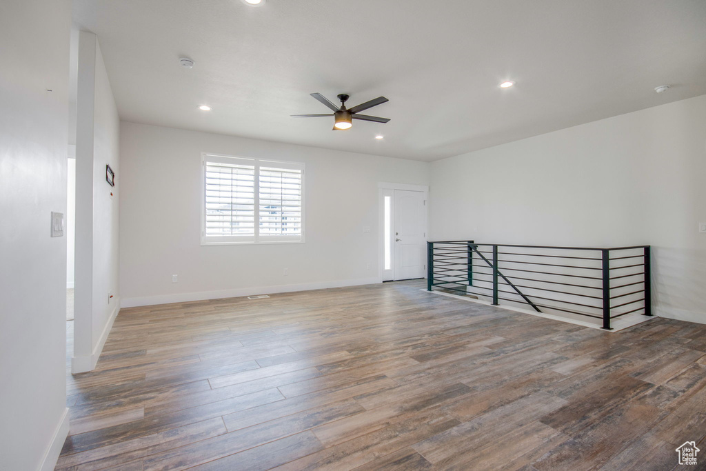 Empty room with hardwood / wood-style flooring and ceiling fan