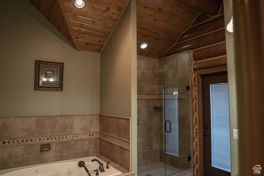 Bathroom featuring vaulted ceiling, wood ceiling, and independent shower and bath