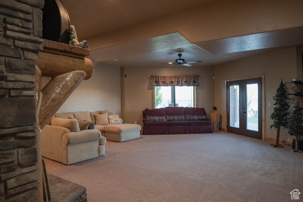Living room featuring french doors, carpet, and ceiling fan