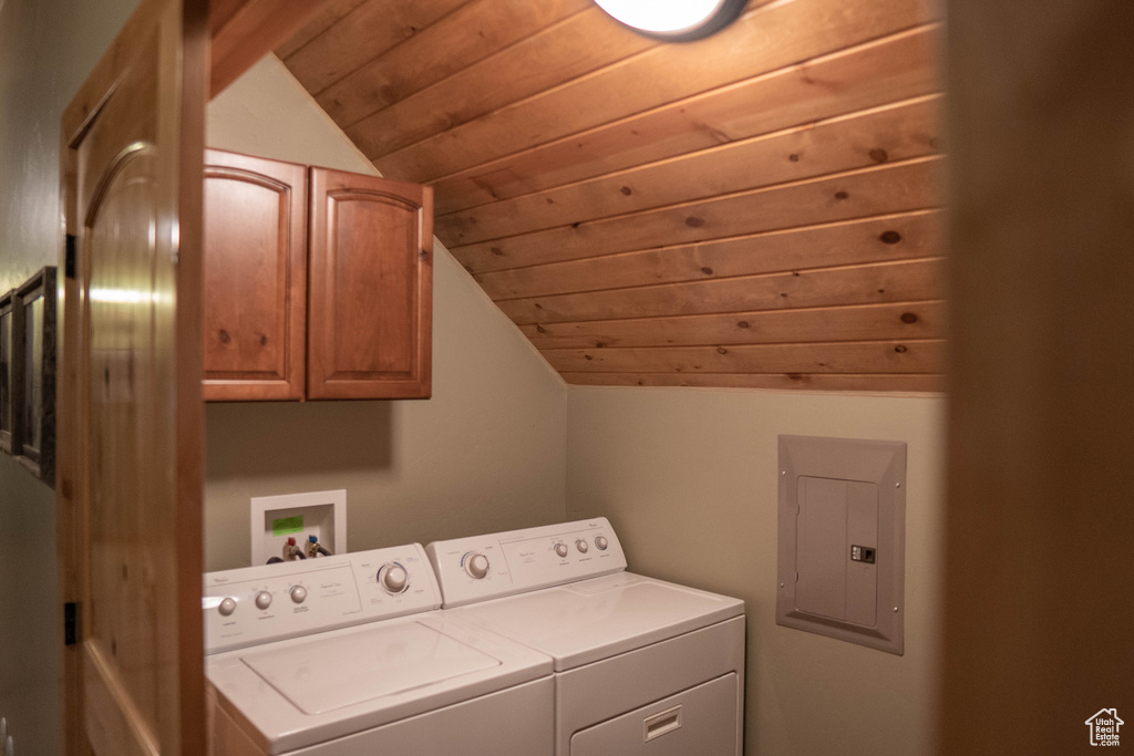 Laundry room with cabinets, washer and clothes dryer, wooden ceiling, and washer hookup