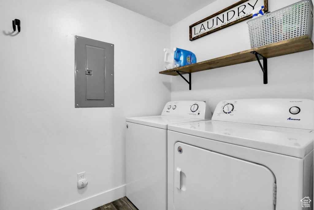 Laundry area with wood-type flooring and separate washer and dryer
