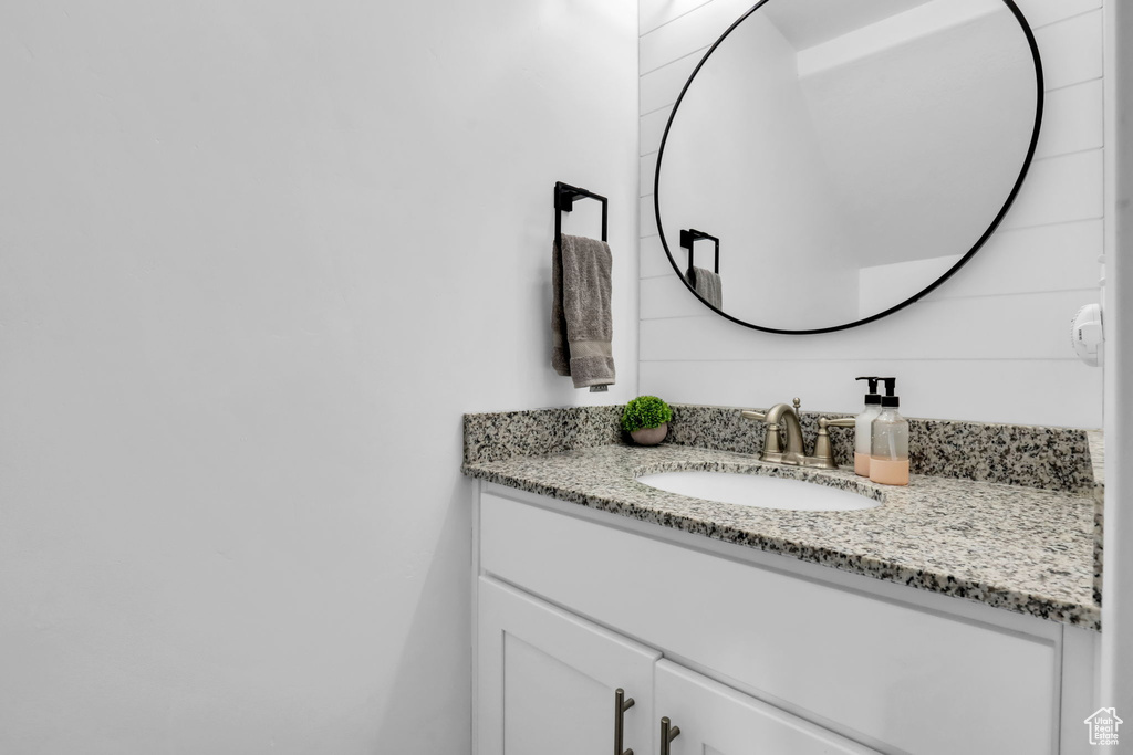 Bathroom featuring vanity with extensive cabinet space