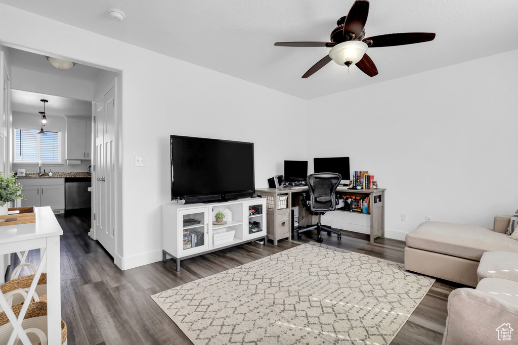 Living room with dark hardwood / wood-style floors and ceiling fan