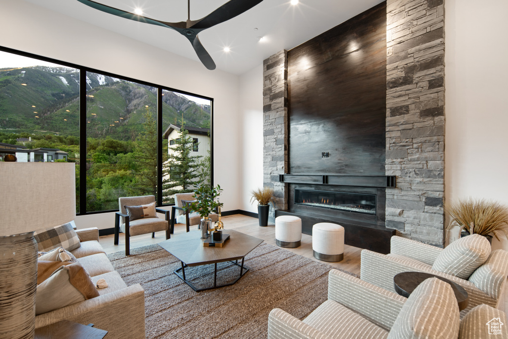 Living room with an outdoor stone fireplace and ceiling fan