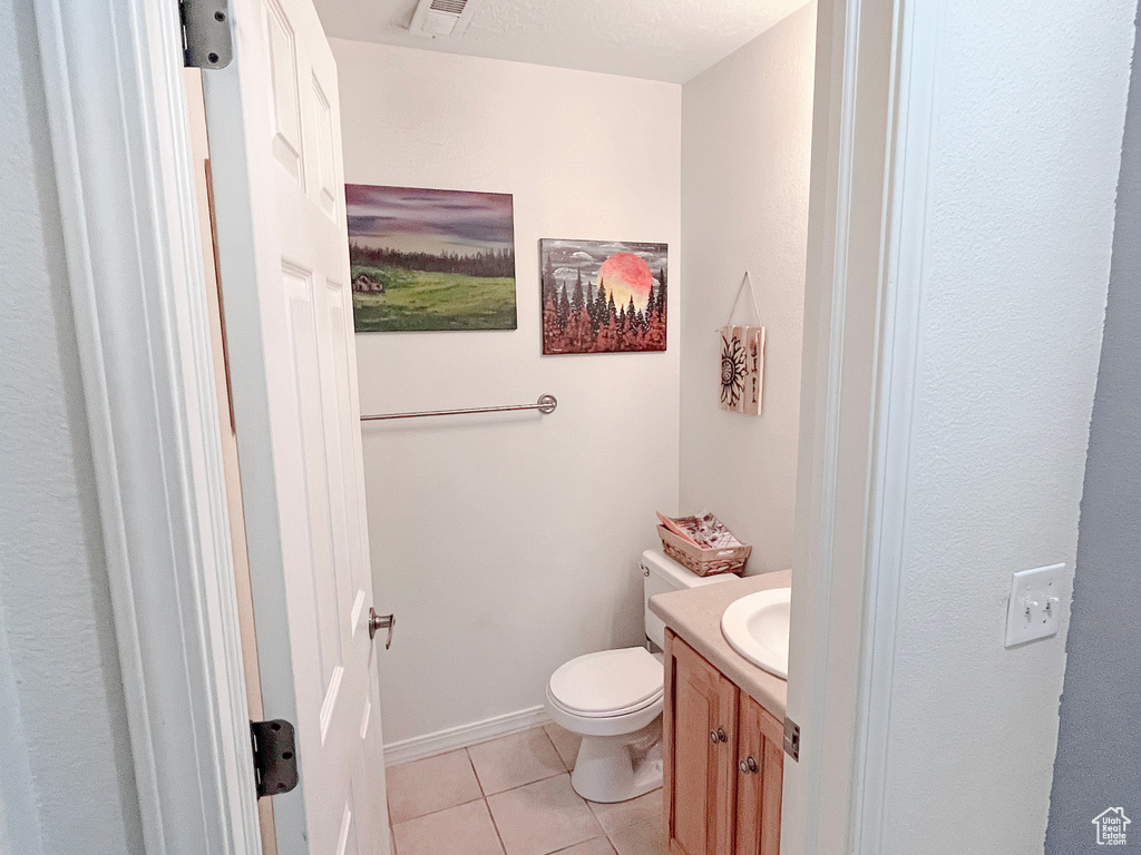 Bathroom featuring vanity, tile flooring, a textured ceiling, and toilet