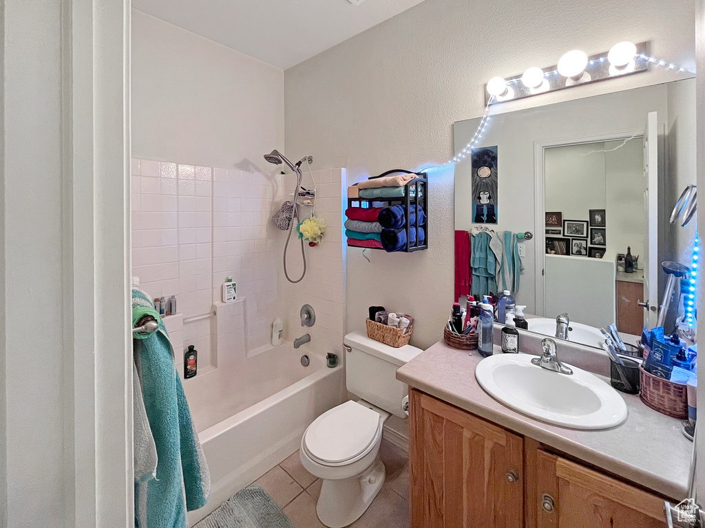 Full bathroom with tile flooring, shower / tub combination, toilet, and vanity