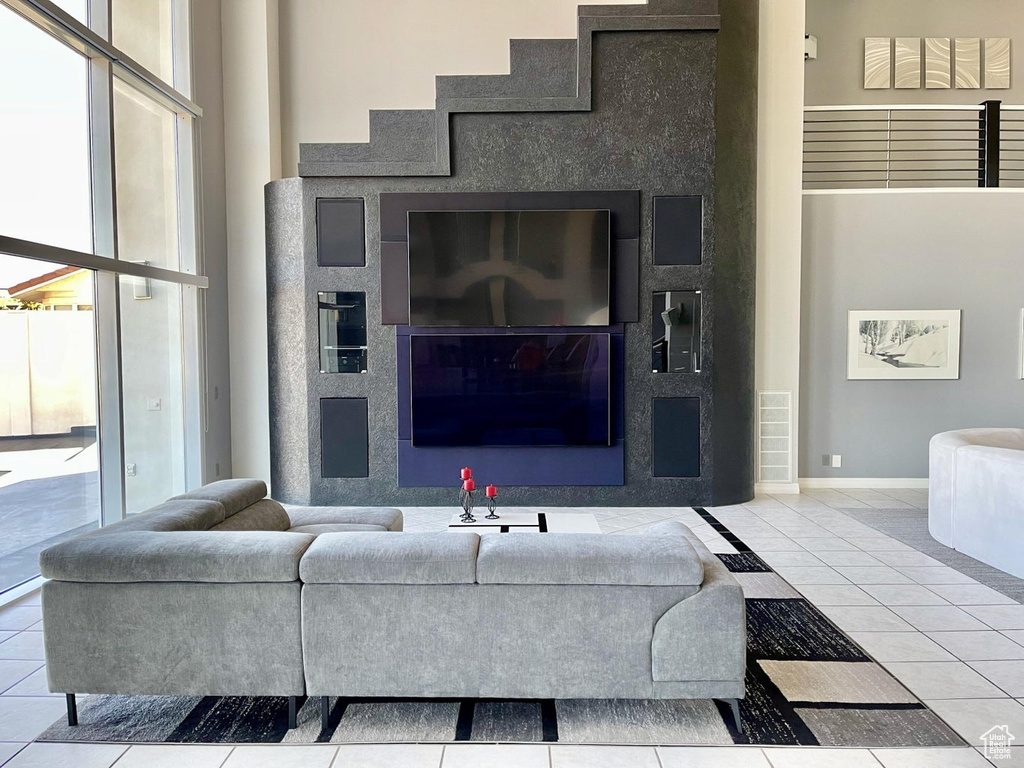 Tiled living room with floor to ceiling windows