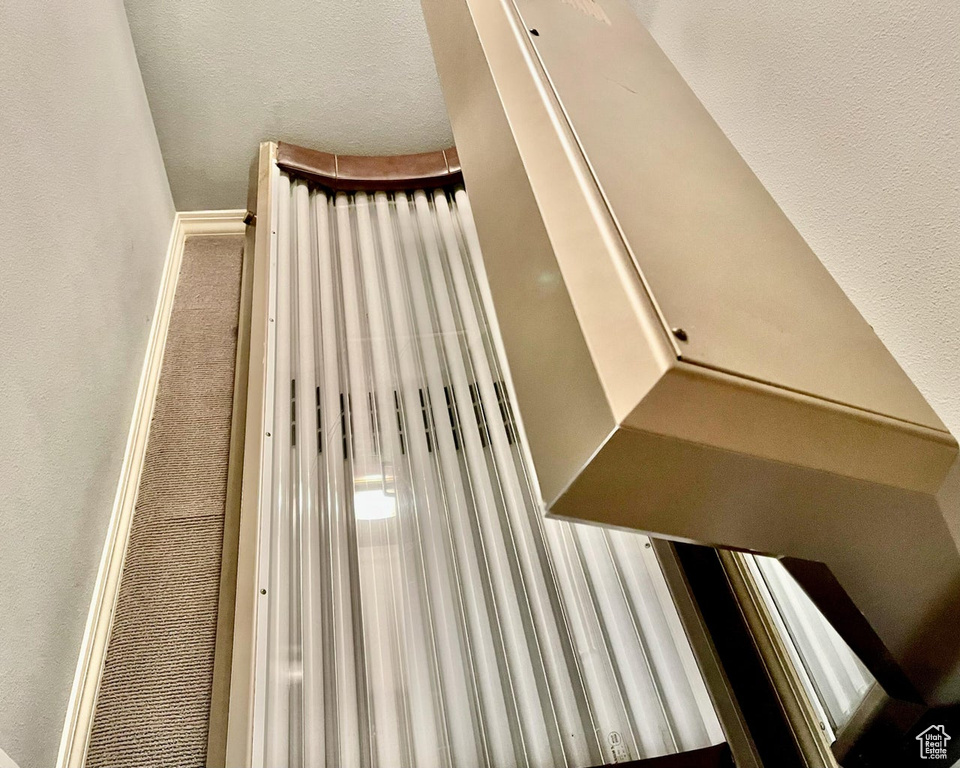 Stairway featuring carpet floors and a textured ceiling