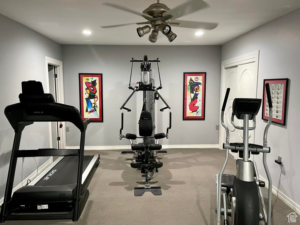 Exercise area with dark carpet and ceiling fan