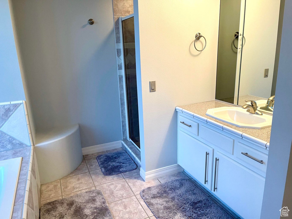 Bathroom with vanity, plus walk in shower, and tile floors