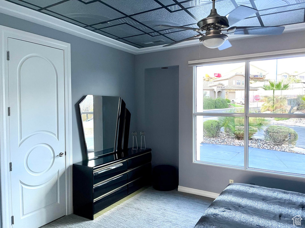 Bedroom featuring multiple windows and ceiling fan