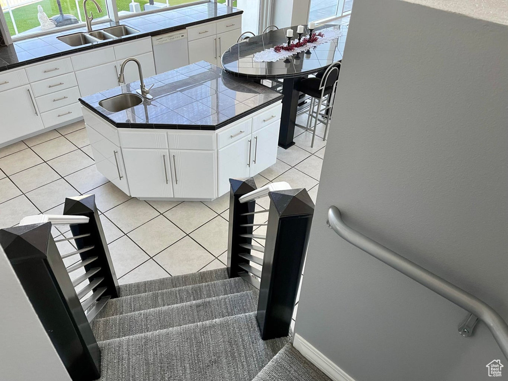 Interior space featuring sink and light tile flooring