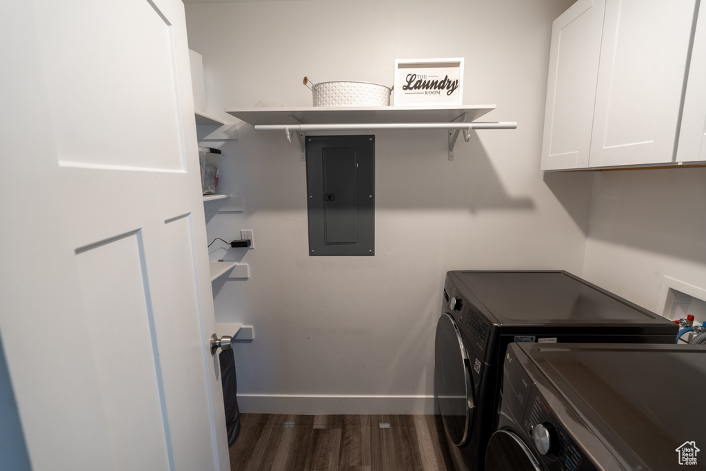 Laundry area with dark hardwood / wood-style flooring, washing machine and dryer, cabinets, and hookup for a washing machine