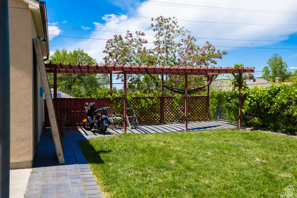 View of yard with a pergola and a patio area