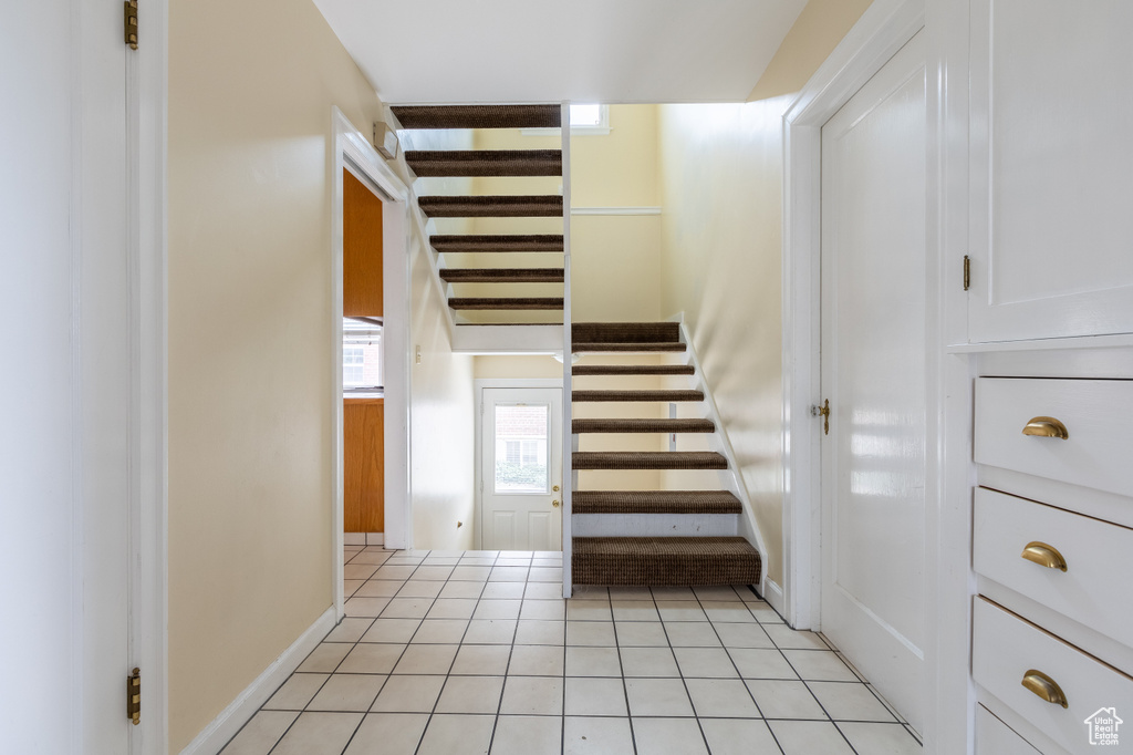 Stairway with light tile floors