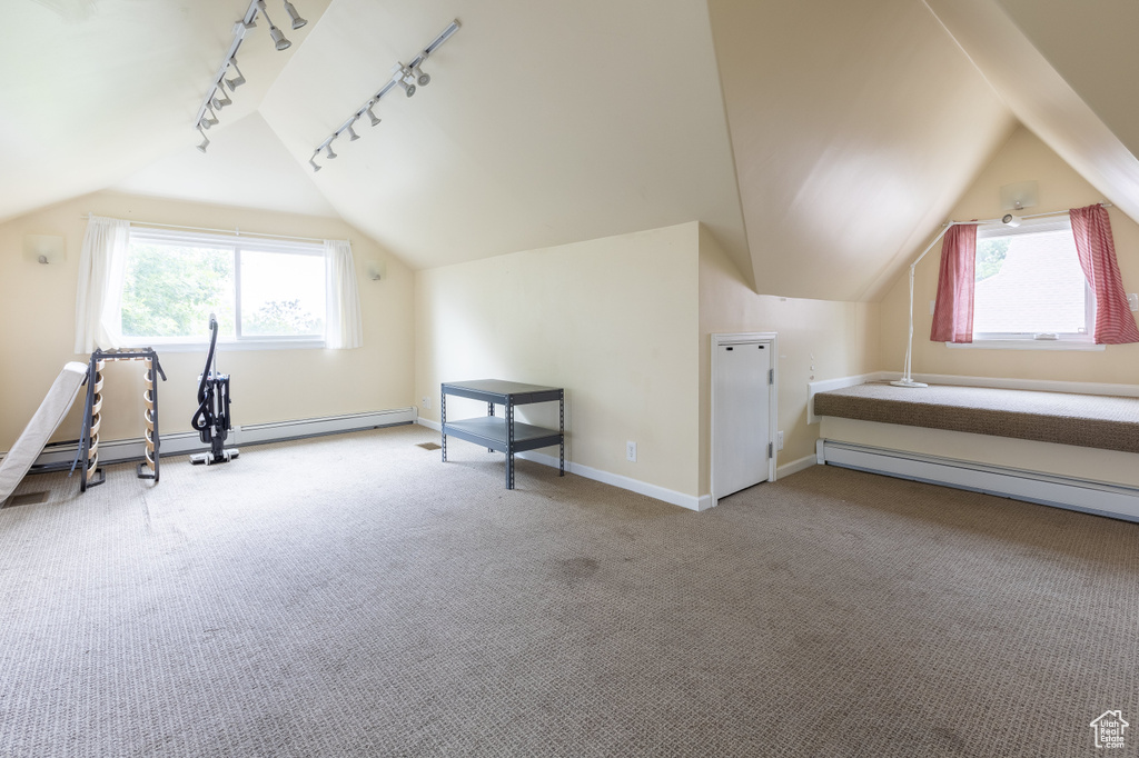 Bonus room featuring light colored carpet, a baseboard radiator, and lofted ceiling