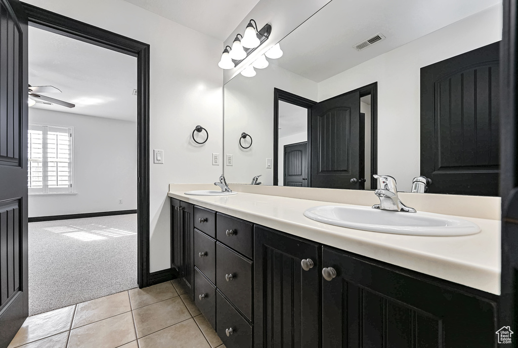 Bathroom featuring double sink, oversized vanity, ceiling fan, and tile floors