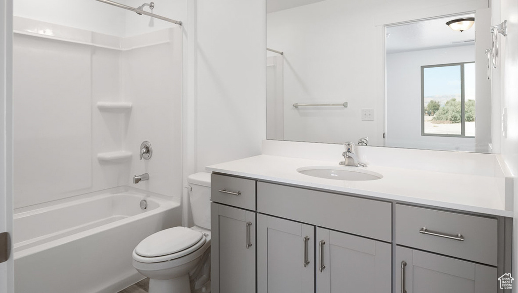 Full bathroom with vanity, toilet, and  shower combination