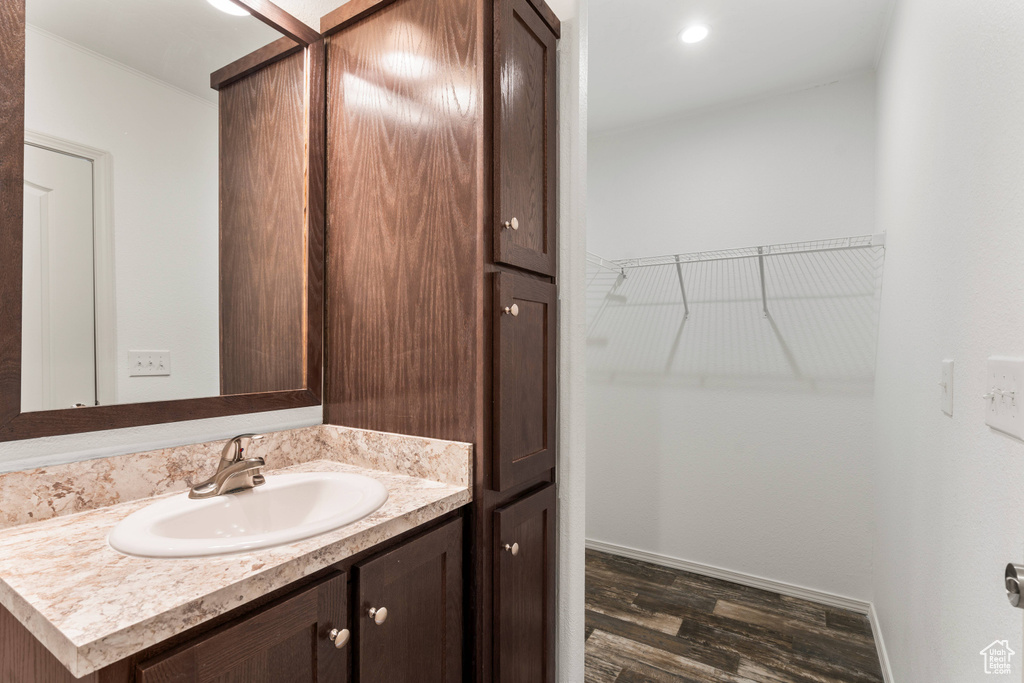 Bathroom featuring hardwood / wood-style flooring and vanity