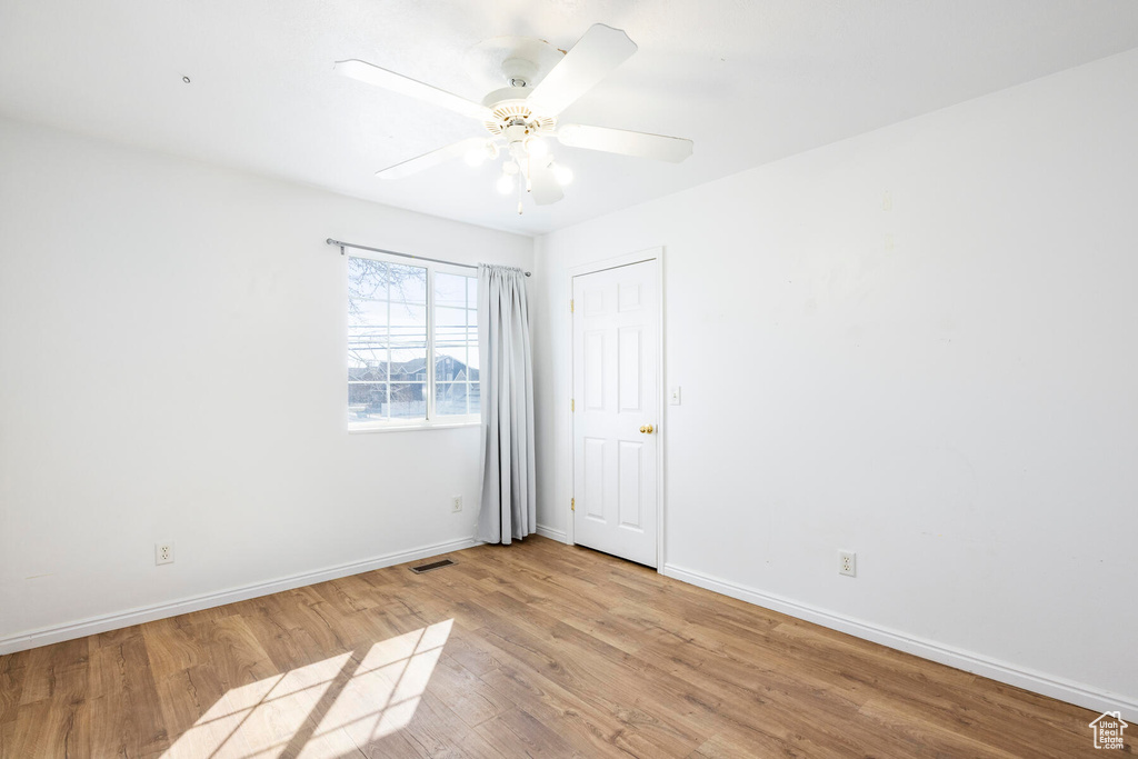 Unfurnished room with light wood-type flooring and ceiling fan