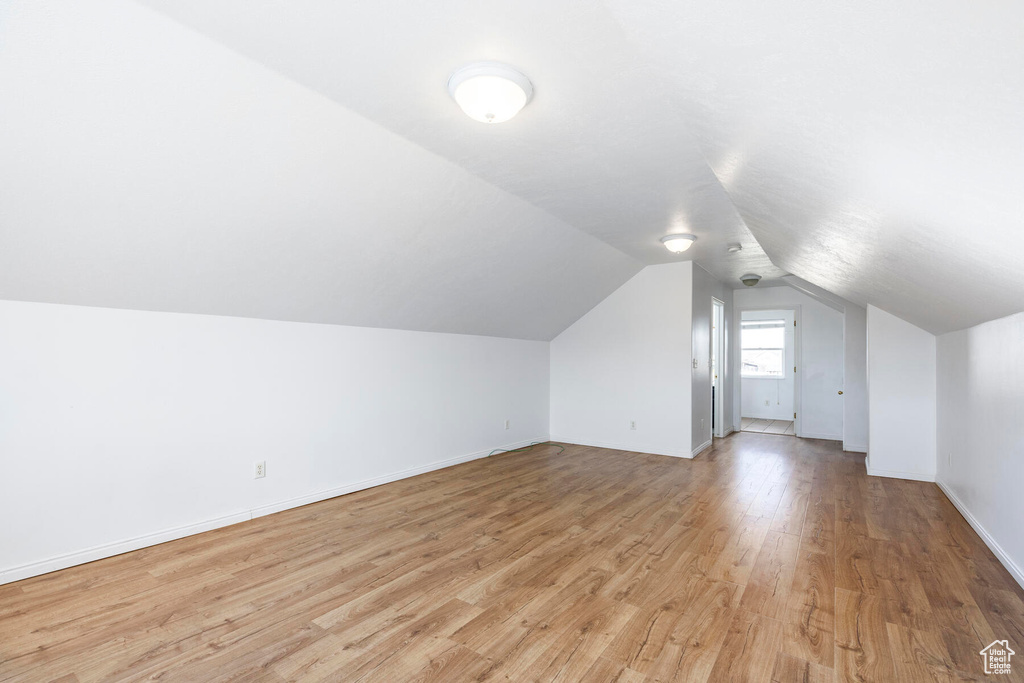Bonus room featuring vaulted ceiling and light hardwood / wood-style flooring