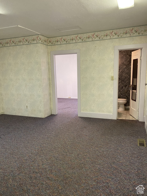 Unfurnished room with carpet floors and a textured ceiling